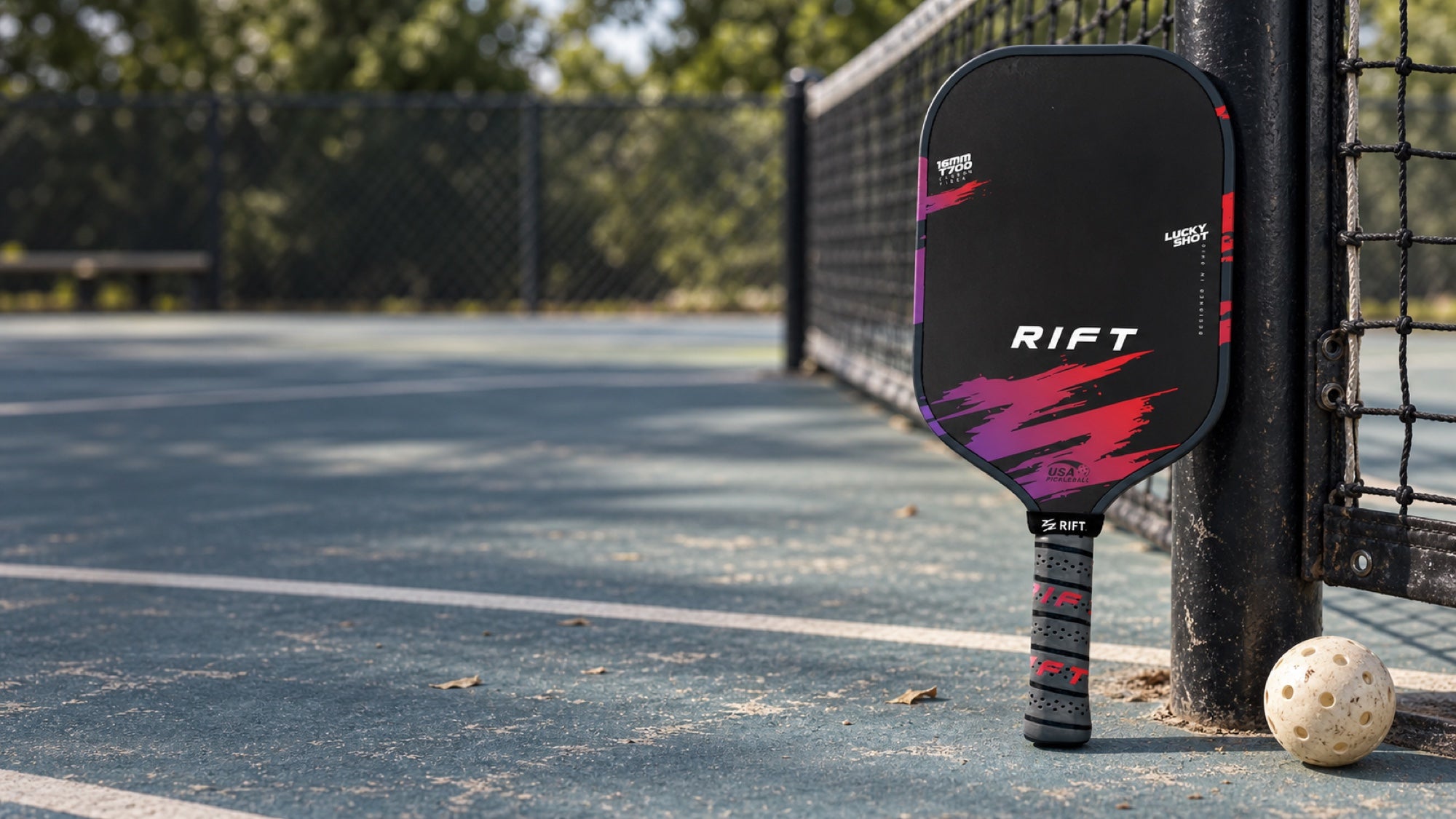 Rift One Pro pickleball paddle beside a court net